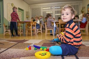 child playing in kindergarten classroom